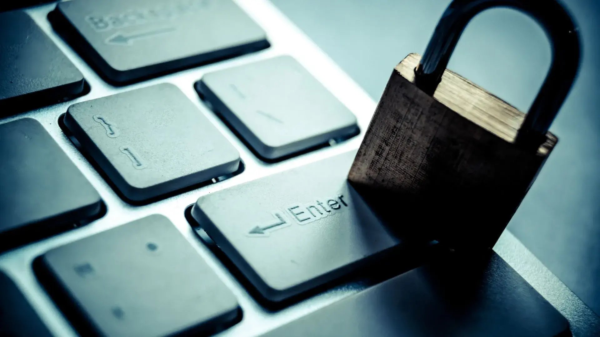 A padlock is placed on top of a keyboard.