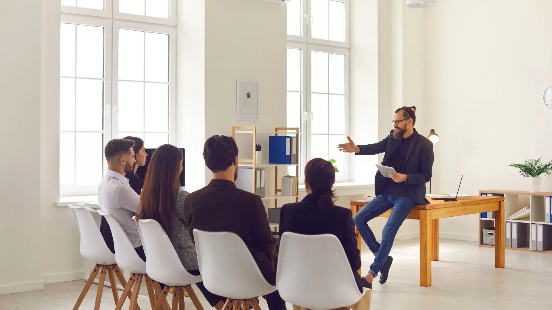 A man conducting security awareness training for a seated group of employees