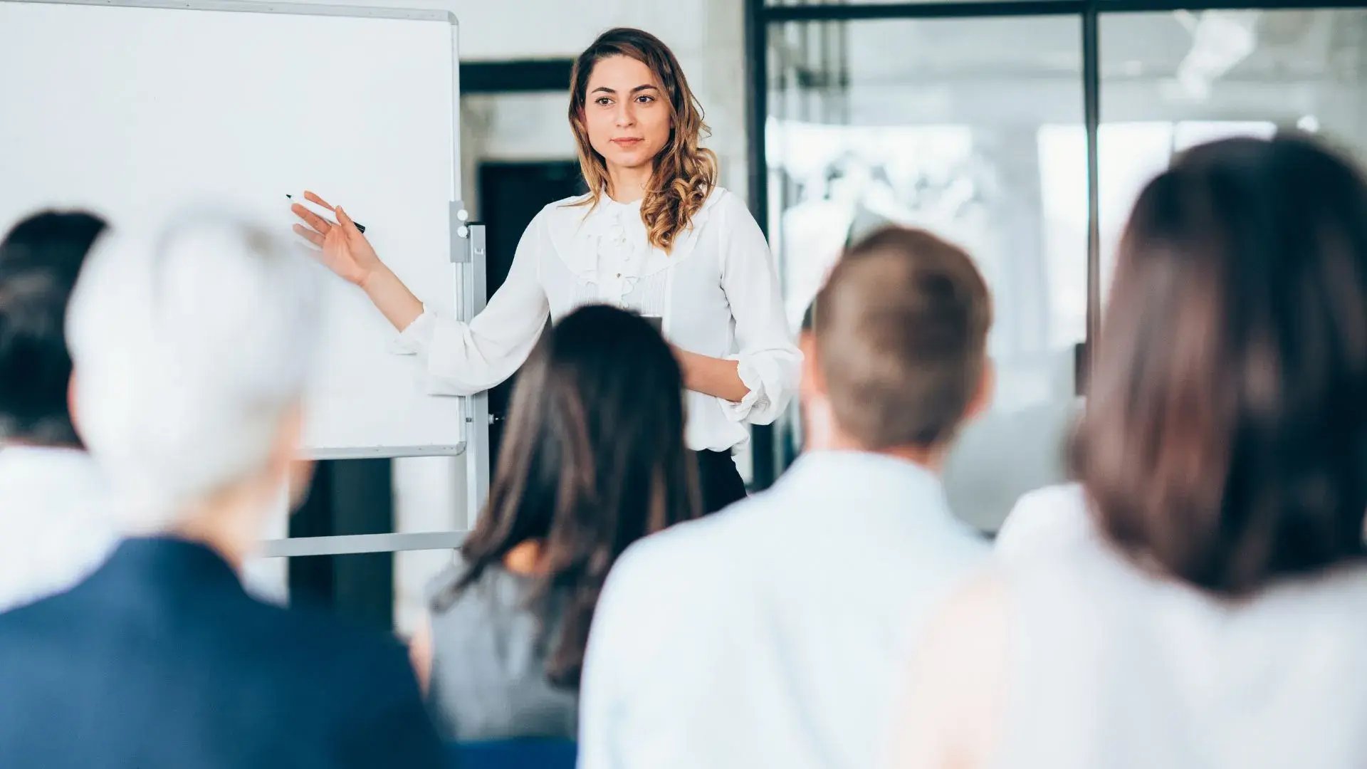 A woman conducting a security awareness training for a corporate group