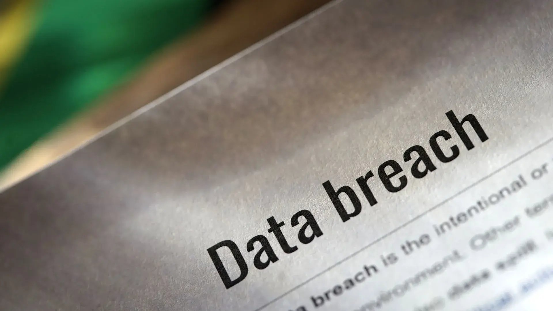 A newspaper clipping with the words “data breach” highlighted and defined