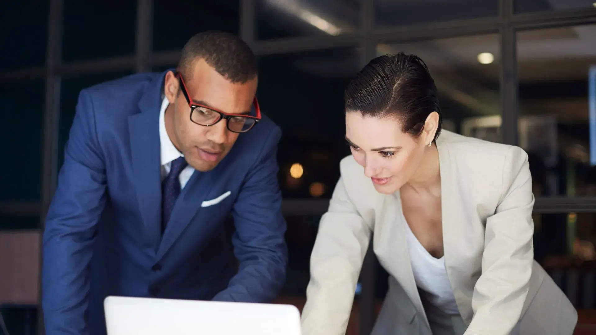 A male and a female cybersecurity specialist crafting a data breach response guide together